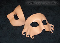 A new twist on an old classic, the Domino mask sports curling shapes at the cheeks.